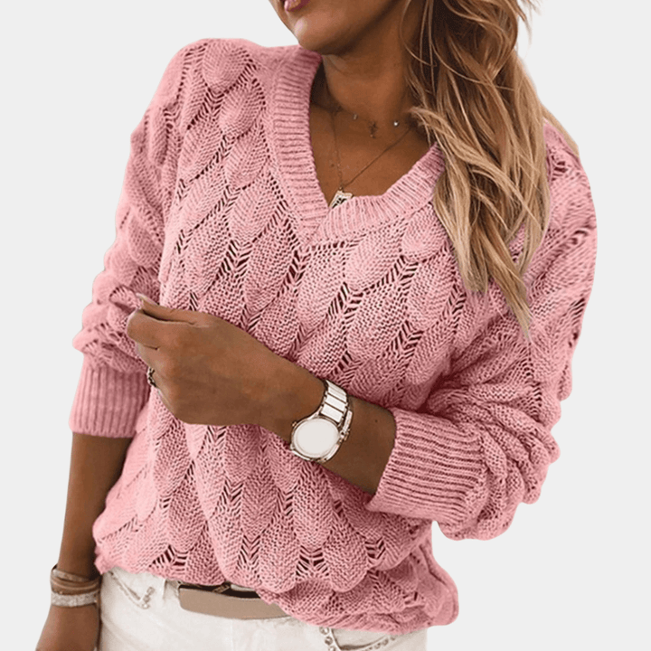 Roze gebreide damestrui met V-hals, lange mouwen en kabelpatroon. Perfect voor casual en stijlvolle outfits. Comfortabele en modieuze dameskleding.