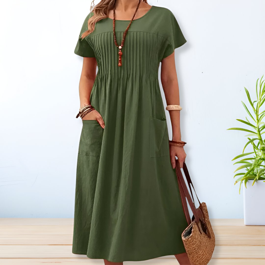 Comfortabele groene midi damesjurk met korte mouwen, ronde hals en zakken, ook verkrijgbaar in ruime maten.