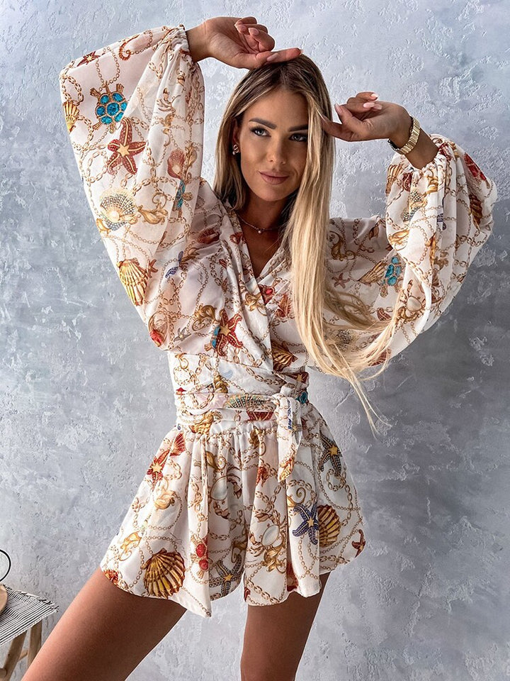 "Chiffon playsuit met tropische print, diepe V-hals, wijde mouwen en elastische taille, ideaal voor zomerse stijl."