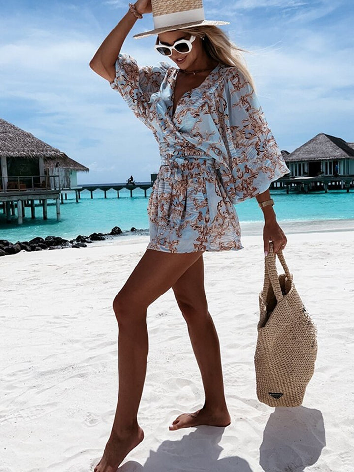"Chiffon playsuit met tropische print, diepe V-hals, wijde mouwen en elastische taille, ideaal voor zomerse stijl."