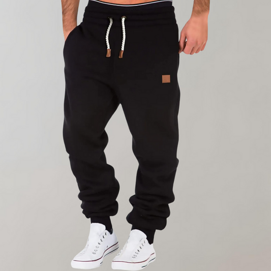 "Comfortabele heren joggingbroek met baggy pasvorm, grijs van kleur, verstelbare tailleband, ideaal voor sport en casual."