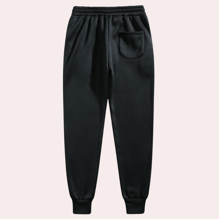 "Comfortabele heren joggingbroek met baggy pasvorm, grijs van kleur, verstelbare tailleband, ideaal voor sport en casual."