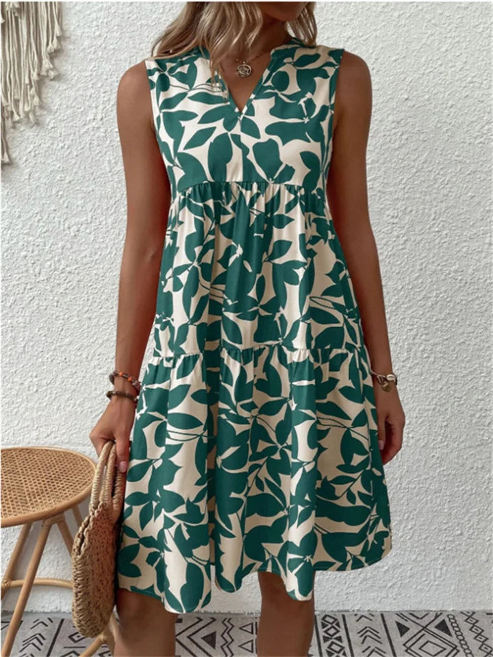 Luchtige dames zomerjurk met vrolijk bloemendessin, midi lengte en A-lijn model, perfect voor warme dagen.