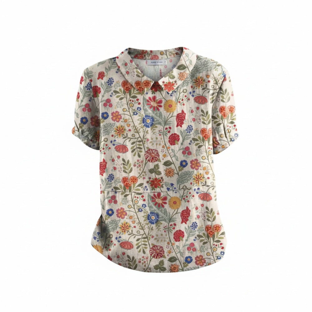 Dames blouse met korte mouwen, vrolijke bloemenprint en klassieke kraag. Perfecte zomer- en voorjaarsmode.