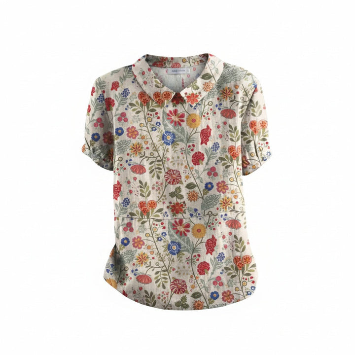 Dames blouse met korte mouwen, vrolijke bloemenprint en klassieke kraag. Perfecte zomer- en voorjaarsmode.