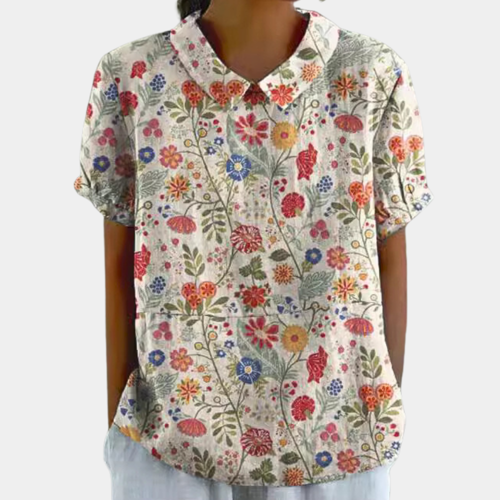 Elegante damesblouse met kleurrijke bloemenprint, korte mouwen en een stijlvolle kraag voor een chique look.