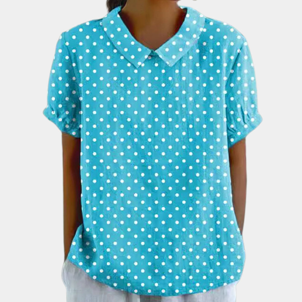 Veelzijdige damesbloes met levendige bloemenprint, korte mouwen en kraag. Geschikt voor casual en elegante outfits.