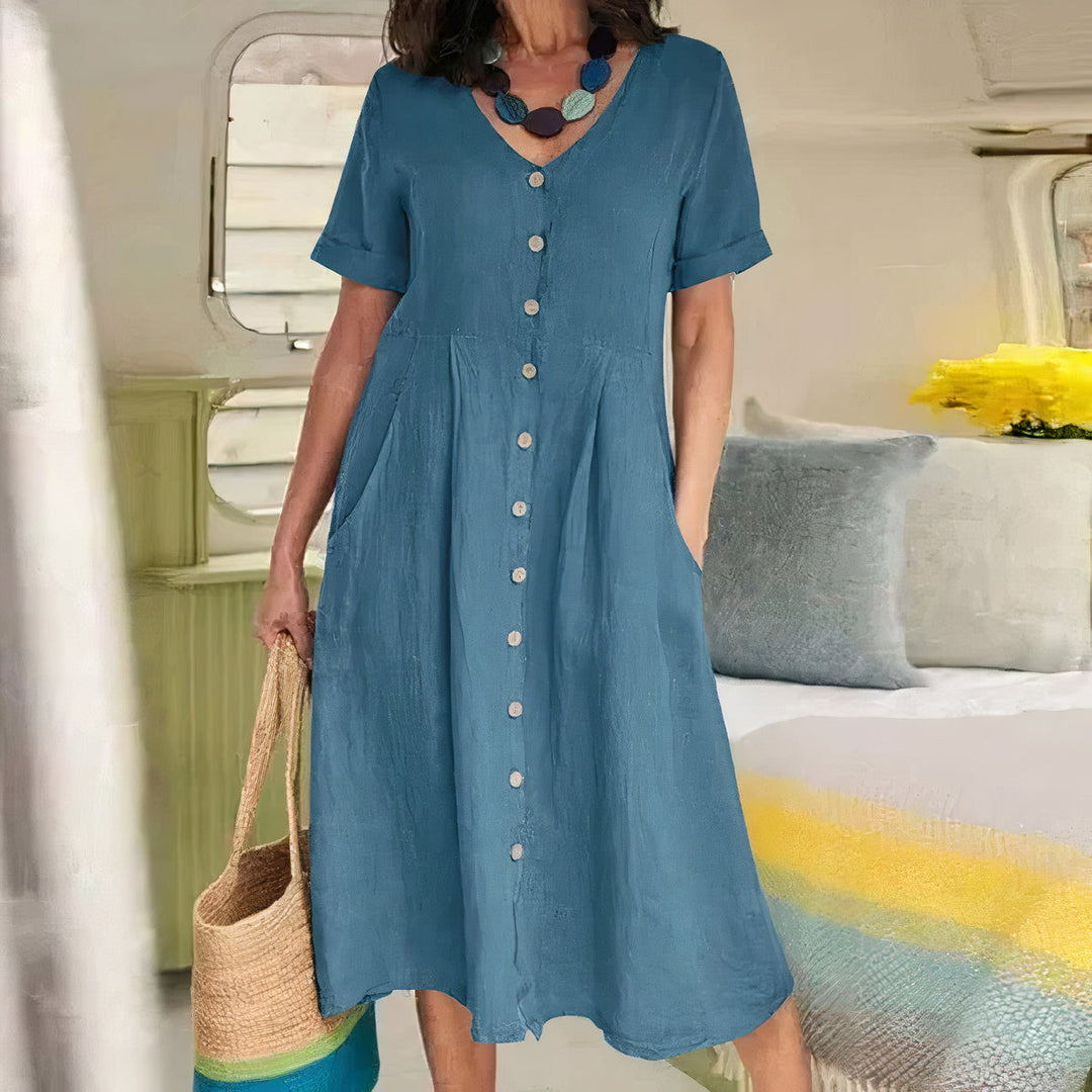Trendy dames midi jurk met V-hals, knoopdetail en zijzakken, perfect voor een relaxte stijl.