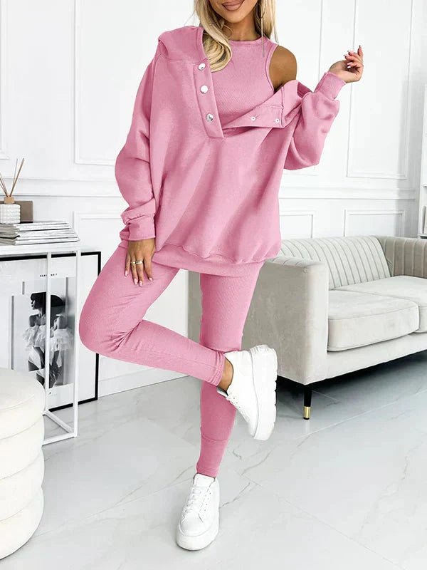 Elegante thuisoutfit: driedelig damespak met comfy hoodie, top en slim fit leggings; ontspannen chic.