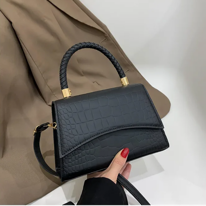 Dames elegante zwarte handtas met bovenhandvat, tijdloze stijl. Ideaal als schouder- of crossbodytas.
