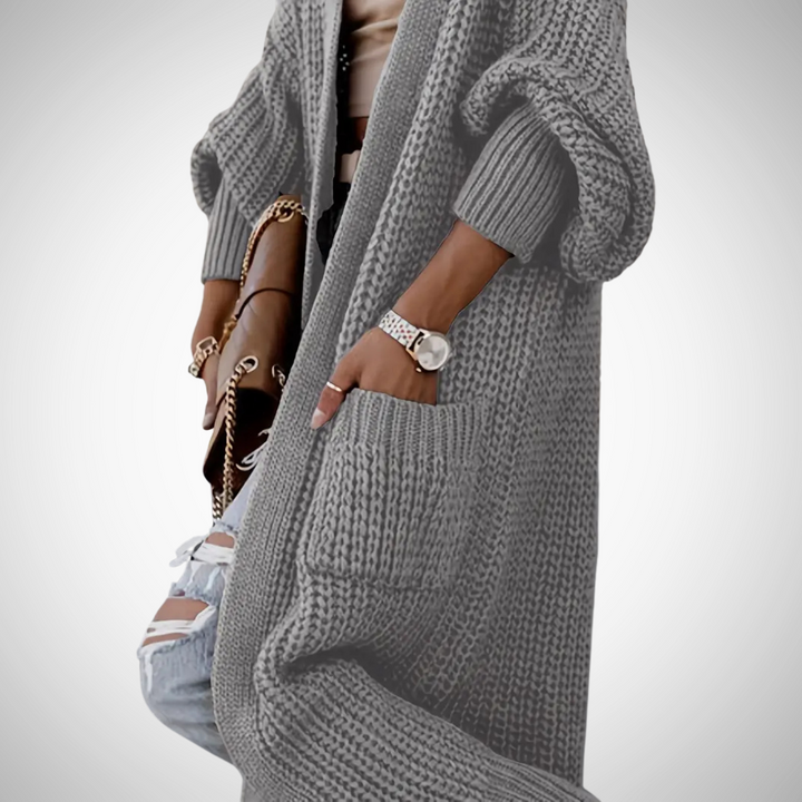 Trendy lang open damesvest met zakken, biedt comfort en warmte. Perfect voor herfstmode en winterkleding.