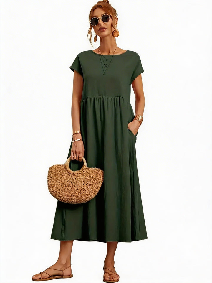 Dames midi jurk met korte mouwen, geplooide rok & zakken. Perfect voor zomerse dagen.