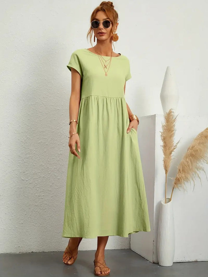 Dames midi jurk met korte mouwen, geplooide rok, zakken. Ideaal voor een stijlvolle look.