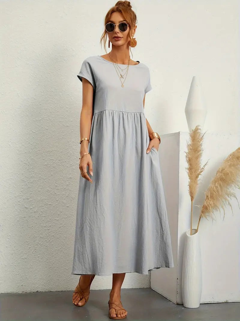 Zomerse groene midi jurk voor vrouwen, korte mouwen, geplooide rok en handige zakken.