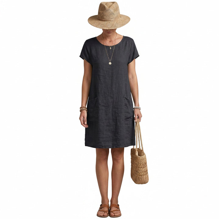 Dames midi jurk met korte mouwen, ronde hals en praktische zakken, ideaal voor een casual zomerlook.