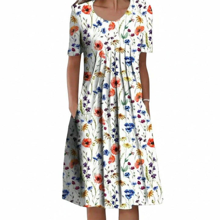 Dames midi jurk met vrolijke bloemenprint, korte mouw en ronde hals, ideaal voor de zomer.