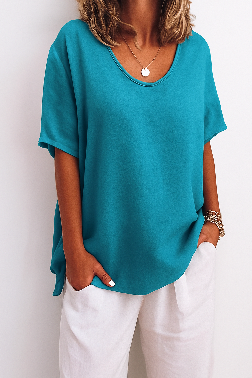Model toont een basic dames t-shirt met ronde hals, losvallend en comfortabel. Trendy zomerse mode.