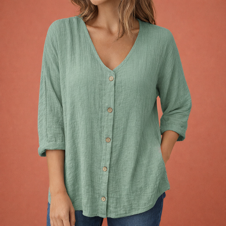 Modieus dames T-shirt, V-hals met knoopjes en driekwart mouwen. Losvallend en comfortabel, perfect voor elk seizoen.