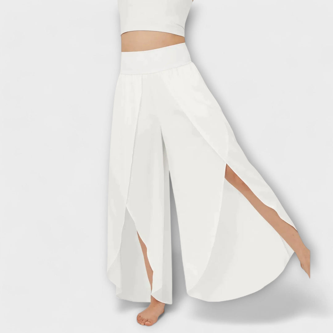 Dames palazzo broek met hoge taille, wijde pijp en zijsplit. Geschikt voor zowel dagelijkse als feestelijke zomeroutfits.