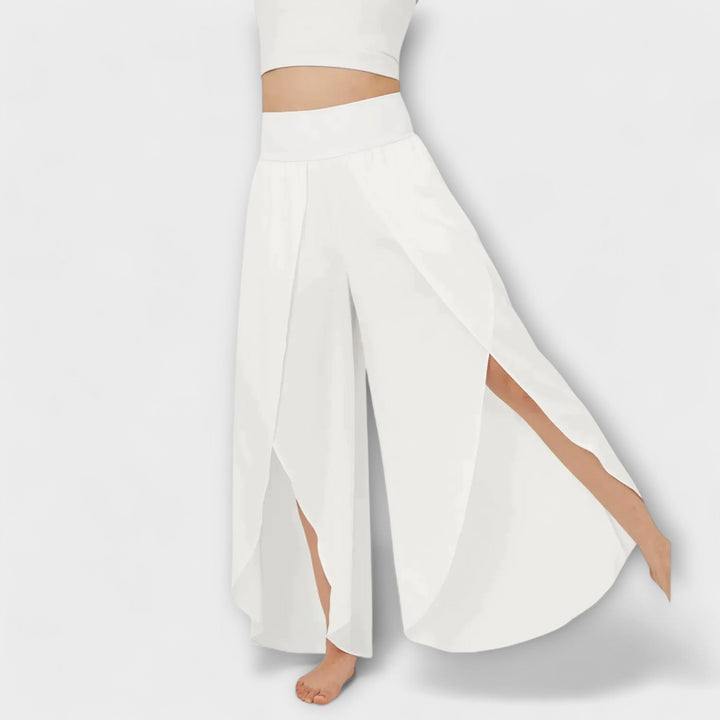 Dames palazzo broek met hoge taille, wijde pijp en zijsplit. Geschikt voor zowel dagelijkse als feestelijke zomeroutfits.