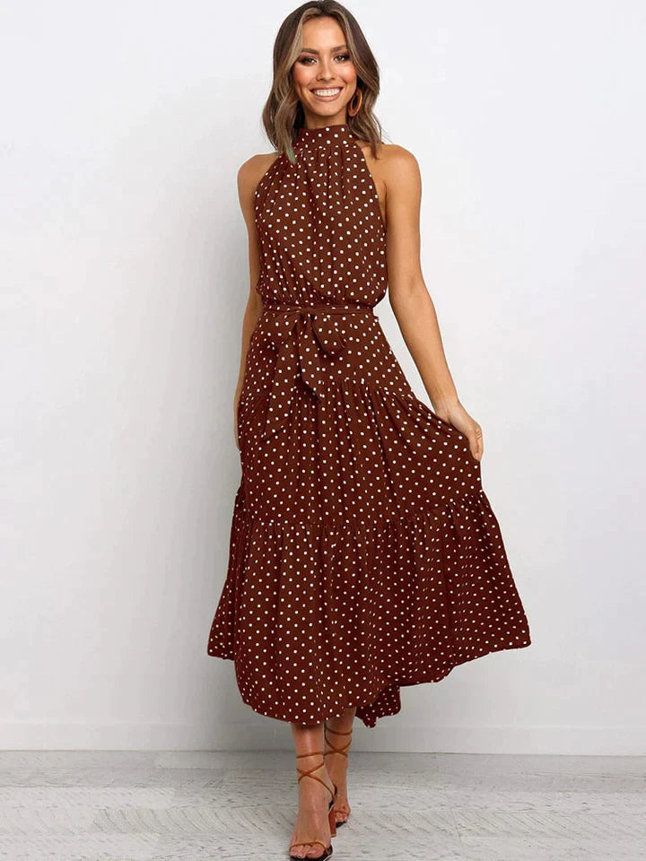 Dames jurk met stippen, halternek en nauwsluitende (slim fit) pasvorm. Ideale elegante zomerkleding.