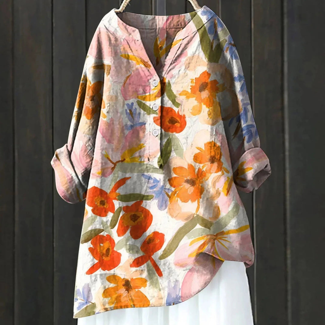 Damesblouse met elegante bloemenprint en V-hals, lange mouwen. Luchtige stof voor een casual-chic zomerlook.