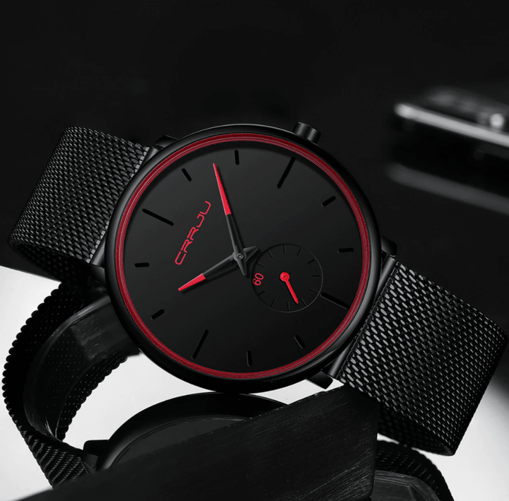 "Dun minimalistisch herenhorloge met elegante zwarte wijzerplaat, roestvrijstalen mesh-band en luxe uitstraling."