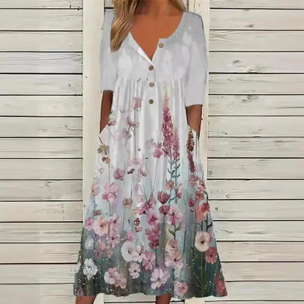 Elegante A-lijn midi jurk met levendige bloemenprint en praktische zakken, ideaal voor zomerse en stijlvolle dagen.