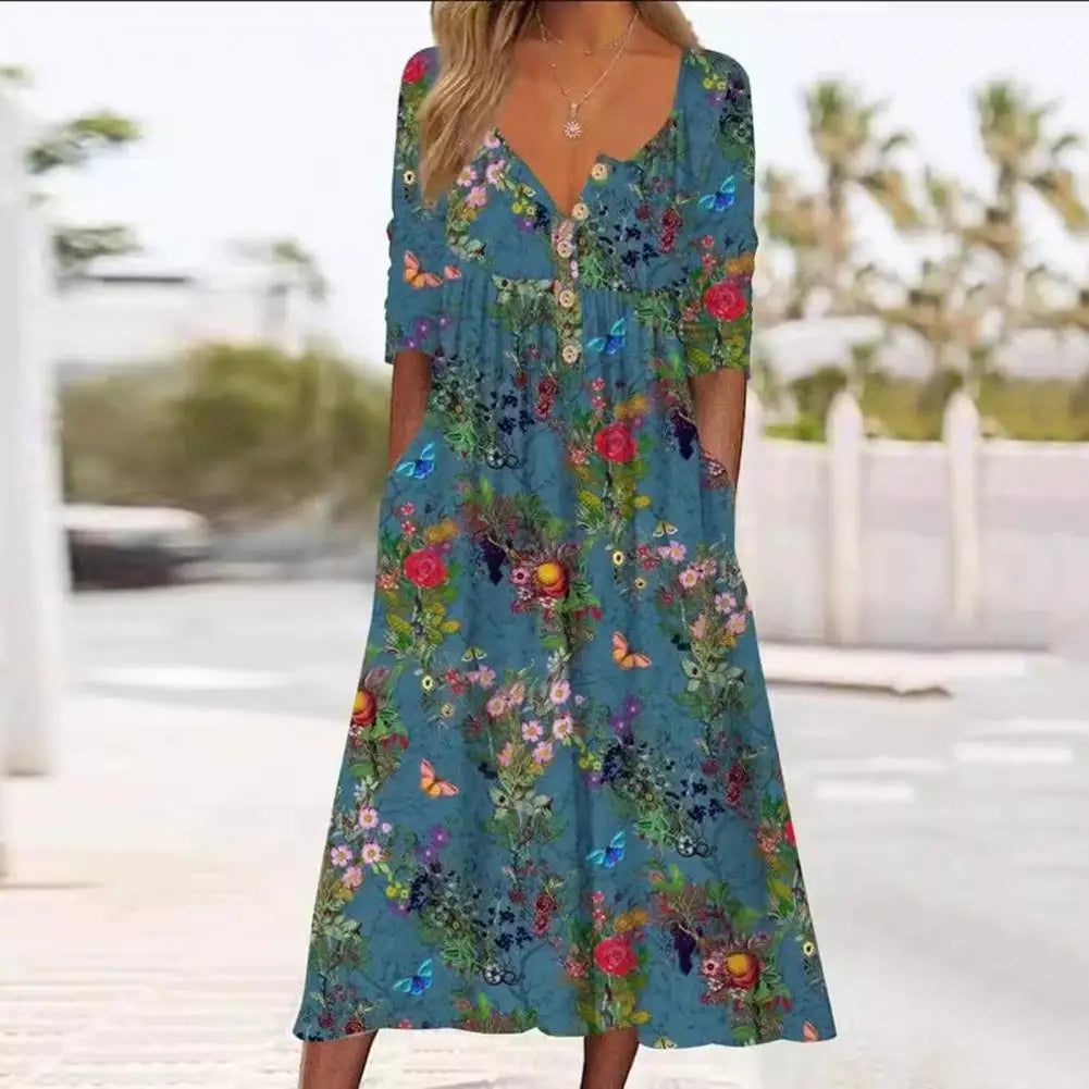 Elegante A-lijn midi jurk met levendige bloemenprint en praktische zakken, ideaal voor zomerse en stijlvolle dagen.