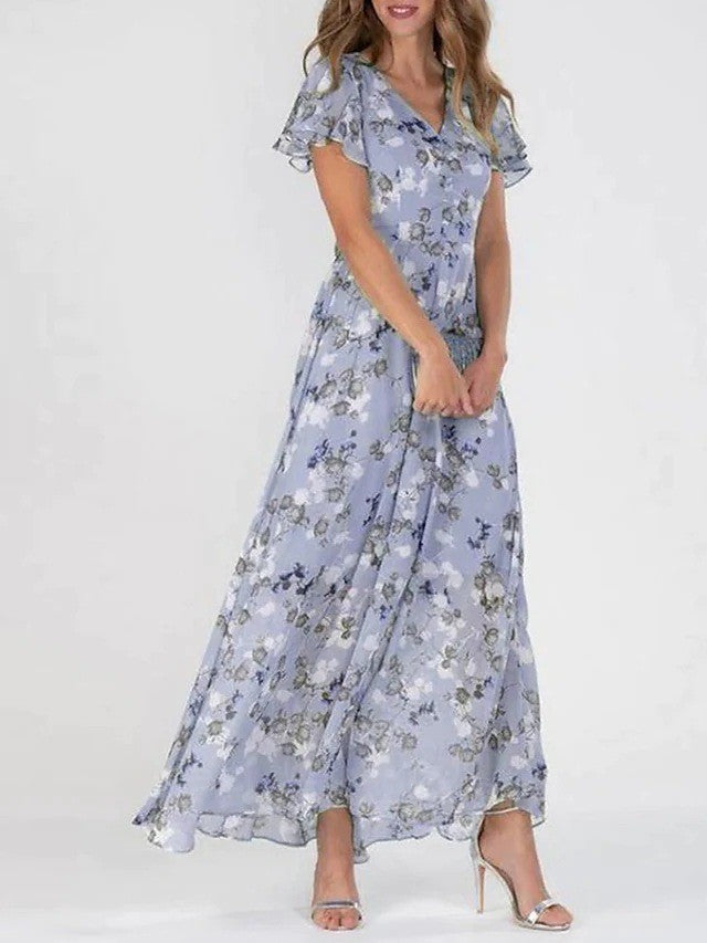 "Elegante chiffon jurk met bloemig patroon, subtiele V-hals en ruffles, ideaal voor zomerse gelegenheden."