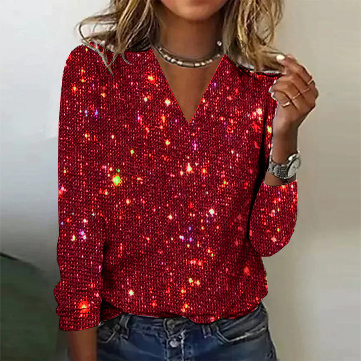 Trendy dames glitterblouse, ideaal als feesttop. De V-hals en glitters zorgen voor een modieuze avondlook.