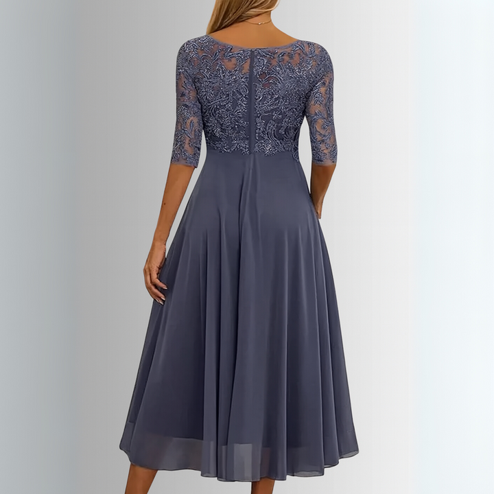 Dames midi jurk met bovenstuk, A-lijn en ronde hals. Een veelzijdige elegante jurk met halve mouw.