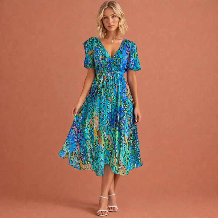 Elegante dames midi jurk met bloemenprint en korte mouwen. Perfect voor zomerse dagen, feestjes of vakantie.