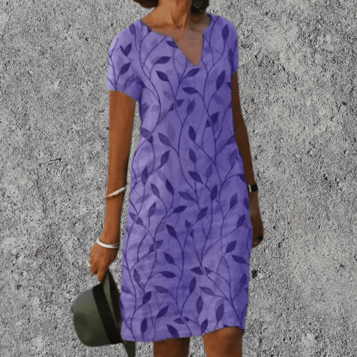 Dames midi jurk met stijlvolle V-hals en korte mouwen, perfect voor zomerse dagen. Veelzijdige damesmode.