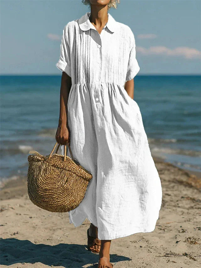 Elegante dames overhemdjurk met knoopsluiting en vloeiende midi pasvorm. Perfect voor zomerse dagen, casual chic.