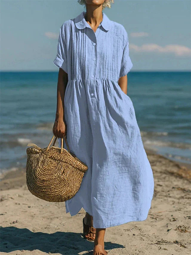 Stijlvolle dames blousejurk, midi lengte, met korte mouwen en knoopsluiting. Ideaal voor lente en zomer.
