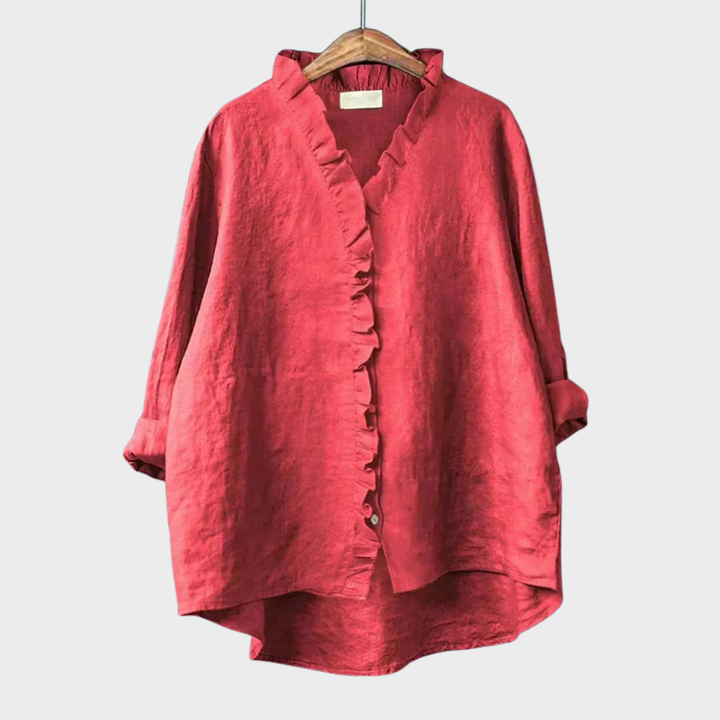 Model draagt elegante damesblouse met lange mouwen, V-hals en ruches, van achteren gezien. Veelzijdig.
