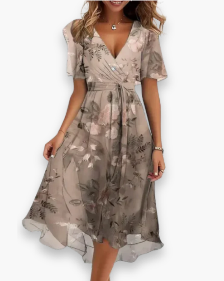Luchtige damesjurk met delicate bloemenprint. Een soepelvallende V-hals jurk voor elke elegante gelegenheid.