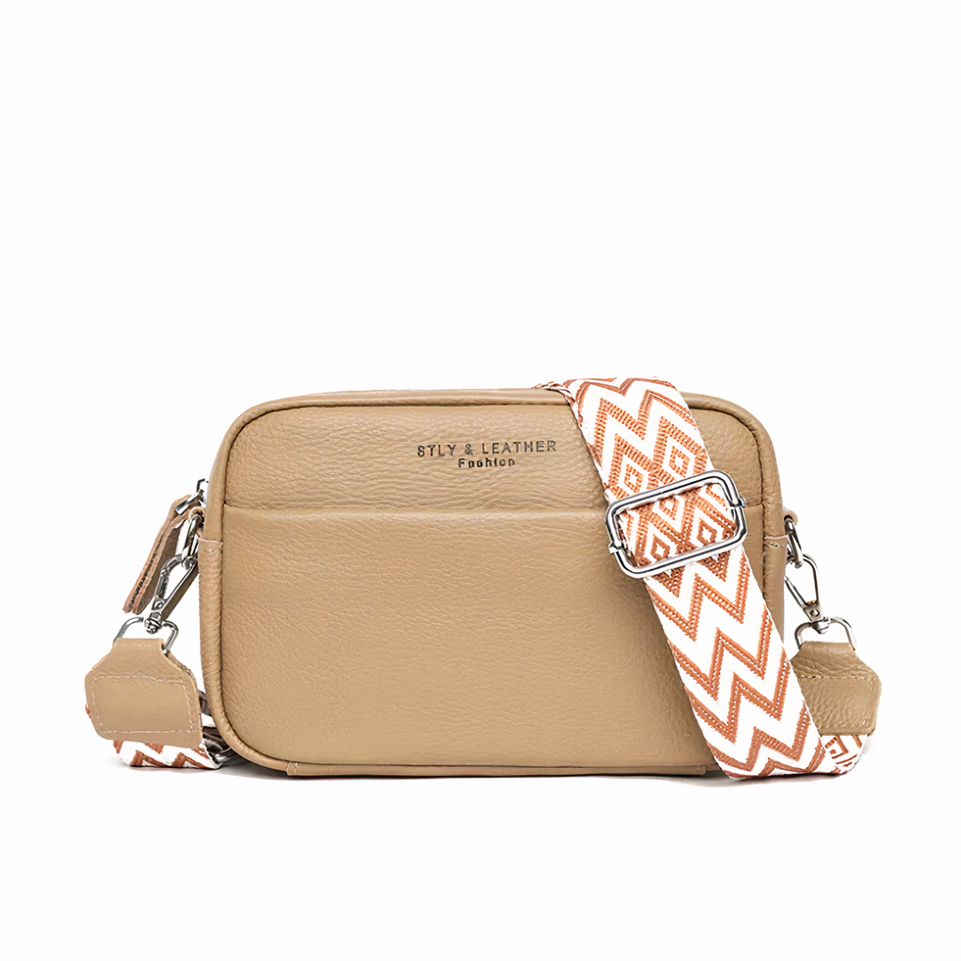 Elegante leren schoudertas voor dames, beige met verstelbare riem en ruime opbergvakken, ideaal voor dagelijks gebruik.