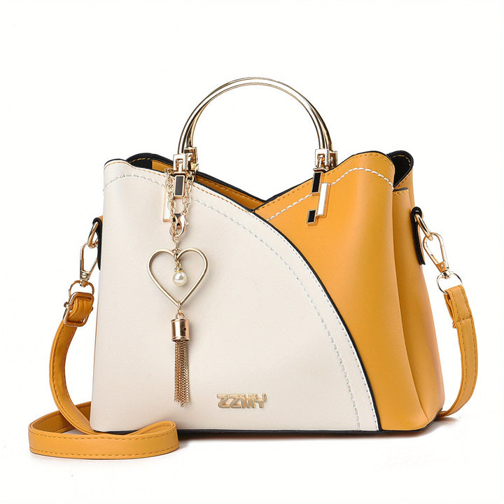 "Elegante luxe leren handtas met stijlvol kleurblokontwerp en kwastjes, perfect voor de moderne vrouw, frontaal gezien."