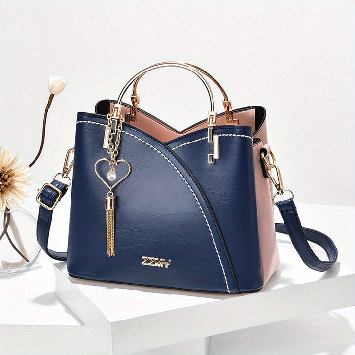 "Elegante luxe leren handtas met stijlvol kleurblokontwerp en kwastjes, perfect voor de moderne vrouw, frontaal gezien."