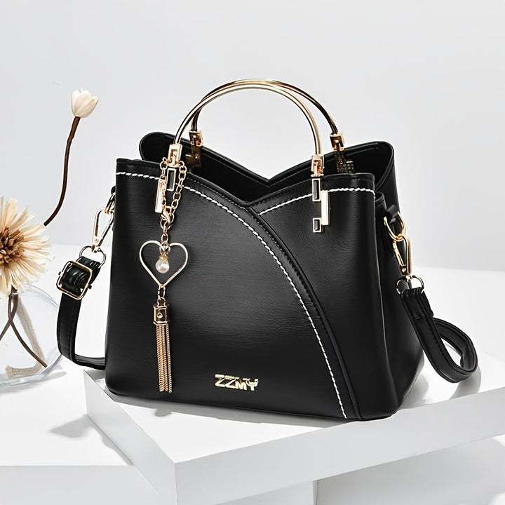 "Elegante luxe leren handtas met stijlvol kleurblokontwerp en kwastjes, perfect voor de moderne vrouw, frontaal gezien."