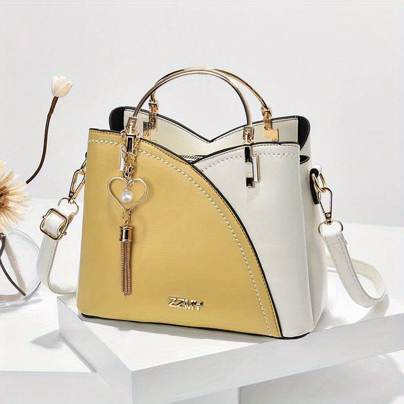 "Elegante luxe leren handtas met stijlvol kleurblokontwerp en kwastjes, perfect voor de moderne vrouw, frontaal gezien."