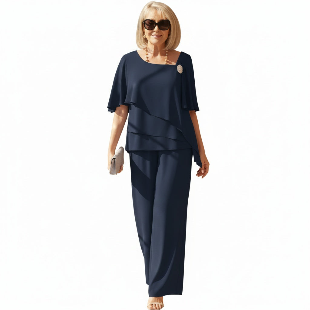 Elegante marineblauwe dames tweedelig set met asymmetrische overlay top en wijde broek voor een casual chique look.