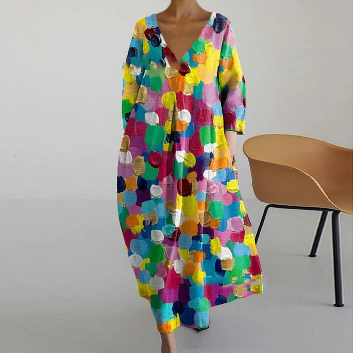"Elegante maxi jurk met abstracte bloemenprint, bohemian stijl, lange mouwen, zakken, V-hals, perfect voor zomerdagen."