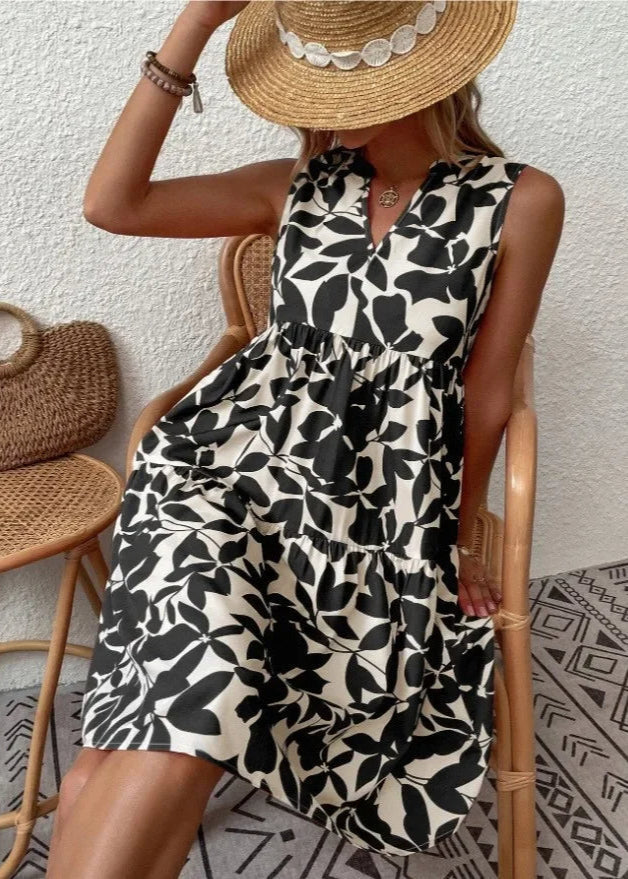 Elegante midi-jurk met V-hals, zomerse bloemenprint, luchtige stof, mouwloos, ideaal voor warme dagen en stijlvolle uitstrali