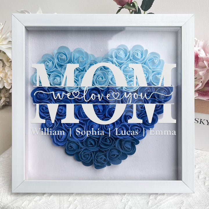 Handgemaakte familie shadowbox met bloemmotief, een gepersonaliseerde herinnering voor elk interieur.