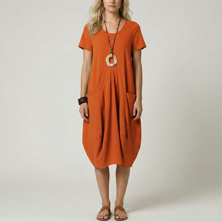 Dames midi jurk met V-hals, korte mouwen, zijzakken en trendy ballonrok. Verkrijgbaar in diverse kleuren.