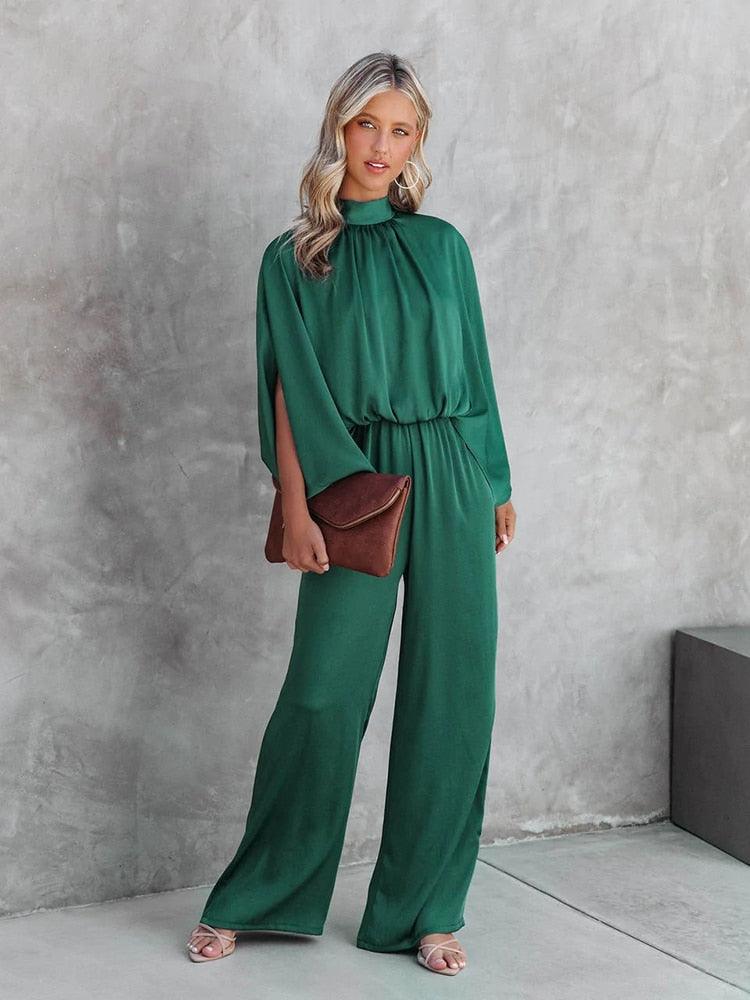 Chique groene dames jumpsuit met capemouwen, perfect voor avondkleding en speciale gelegenheden, tijdloze stijl.