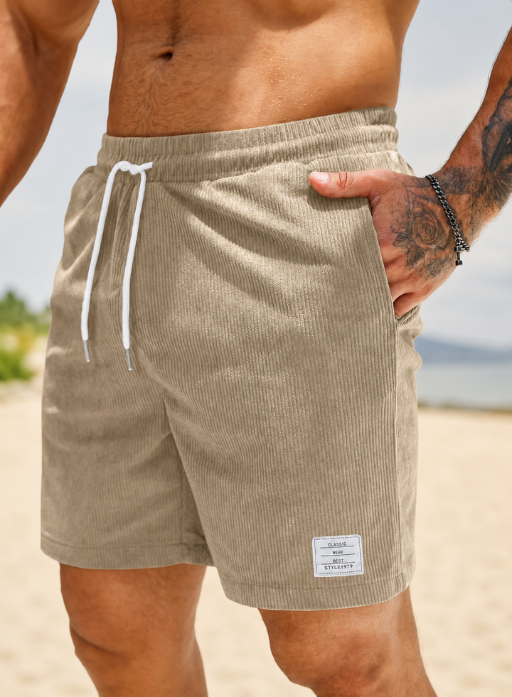 Zwarte heren vrijetijdsshorts met relaxte pasvorm, trekkoord en elastische tailleband.